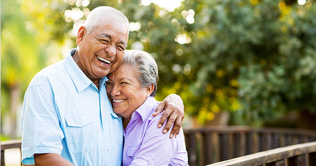 Elder couple hugging and smiling