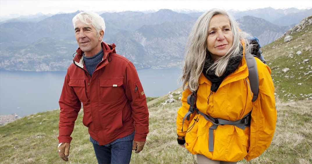 Elder couple walking on the mountains 