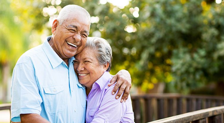 Elder couple hugging and smiling