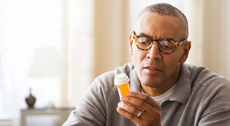 Men reading the label of his medicine